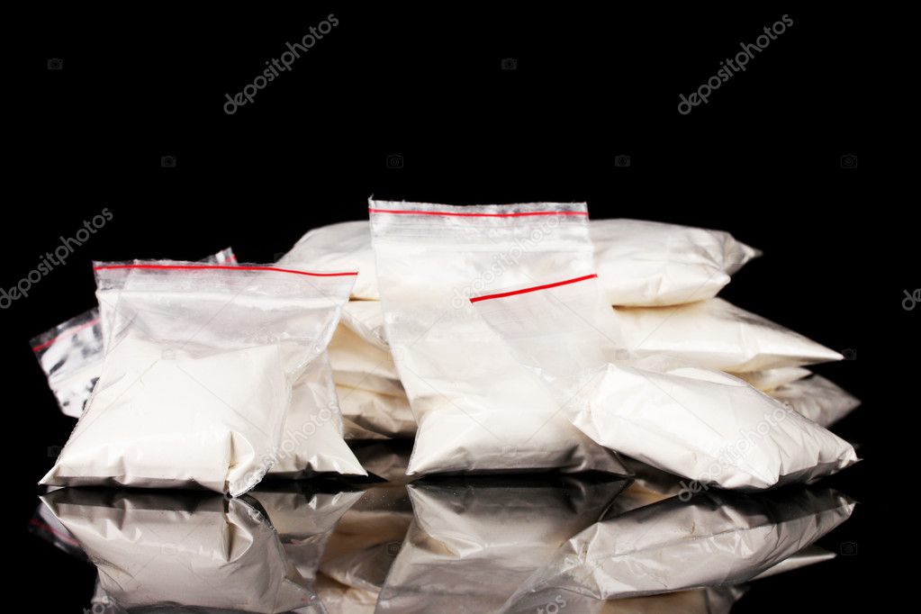 Cocaine in packages on black background
