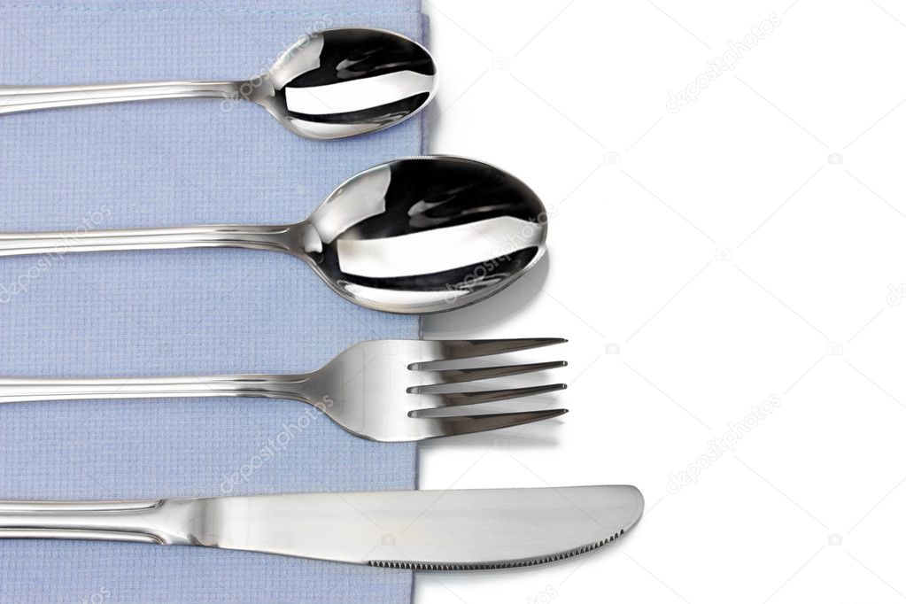 Fork, spoon and knife in a blue cloth isolated on white