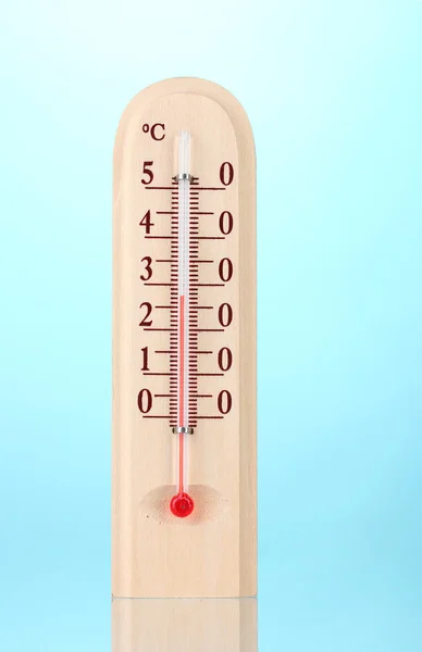 Wooden thermometer on blue — Stock Photo, Image