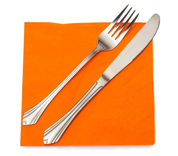 Tenedor y cuchillo en un paño naranja aislado en blanco — Foto de Stock