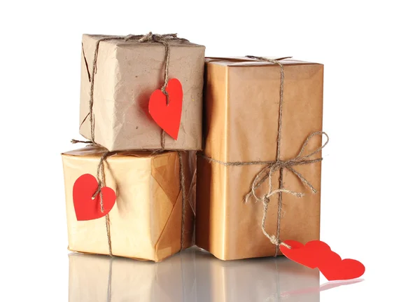 Tre pacchi con etichette bianche a forma di cuore isolate su bianco — Foto Stock