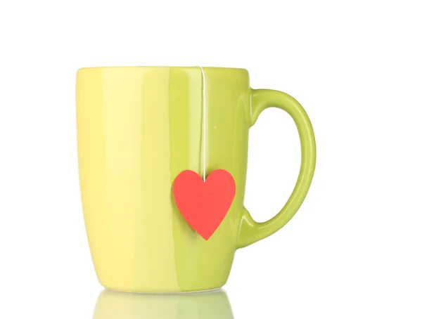 Green cup and tea bag with red heart-shaped label isolated on white — Stock Photo, Image