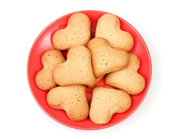 Heart-shaped cookies on red saucer isolated on white — Stock Photo, Image