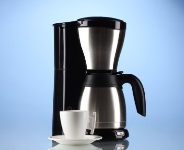 Coffee maker with white cup on blue background clipart