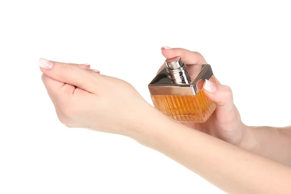 Manos de las mujeres y frasco de perfume aislado en blanco — Foto de Stock