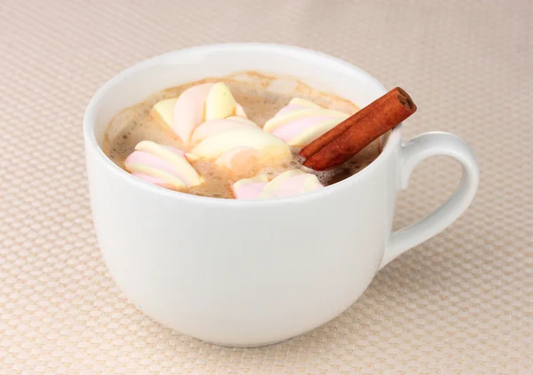 Cup of cappucino with marshmallows and cinnamon on beige background — Stock Photo, Image