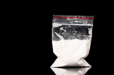 Cocaine in package on black background clipart