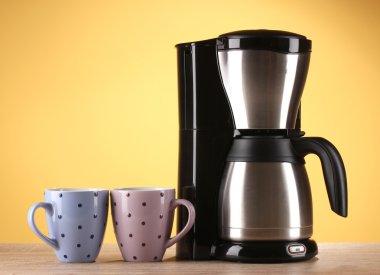 Coffee maker on yellow background clipart