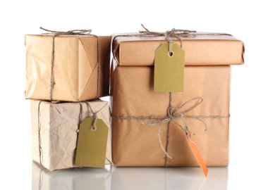 Many parcels wrapped in brown paper tied with twine and with blank labels i clipart