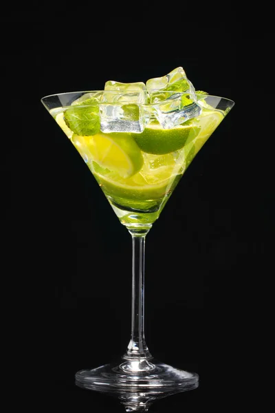 Glass of cocktail with lime and mint on black background — Stock Photo, Image