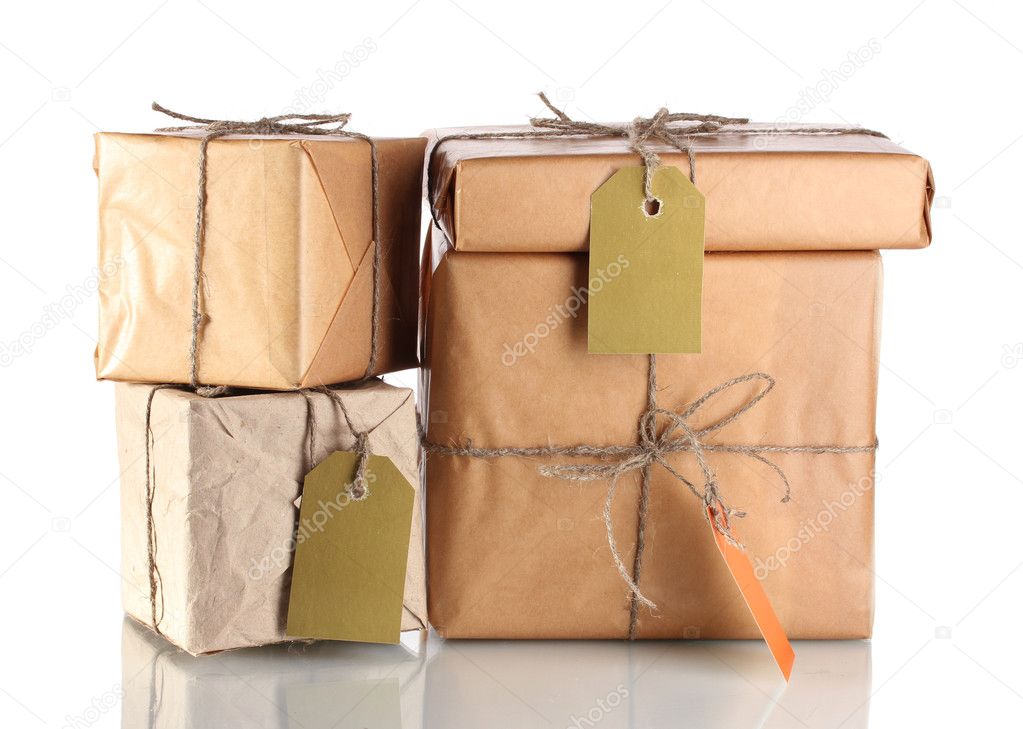 Many parcels wrapped in brown paper tied with twine and with blank labels i