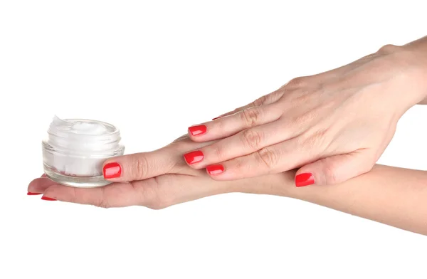 Женские руки с маникюром удерживая крем изолирован на белом — стоковое фото
