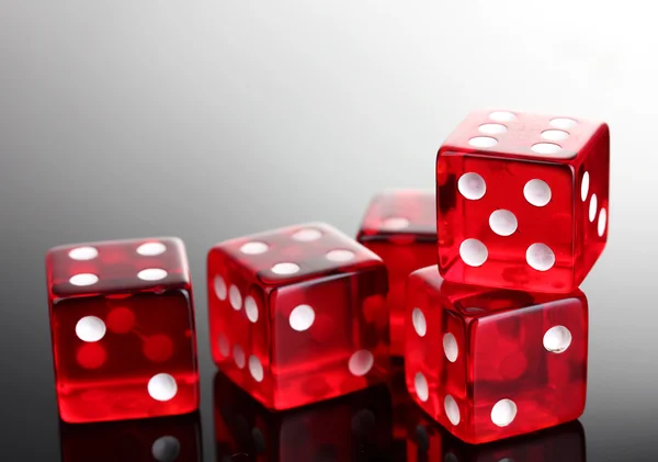 Red dices on grey background — Stock Photo, Image