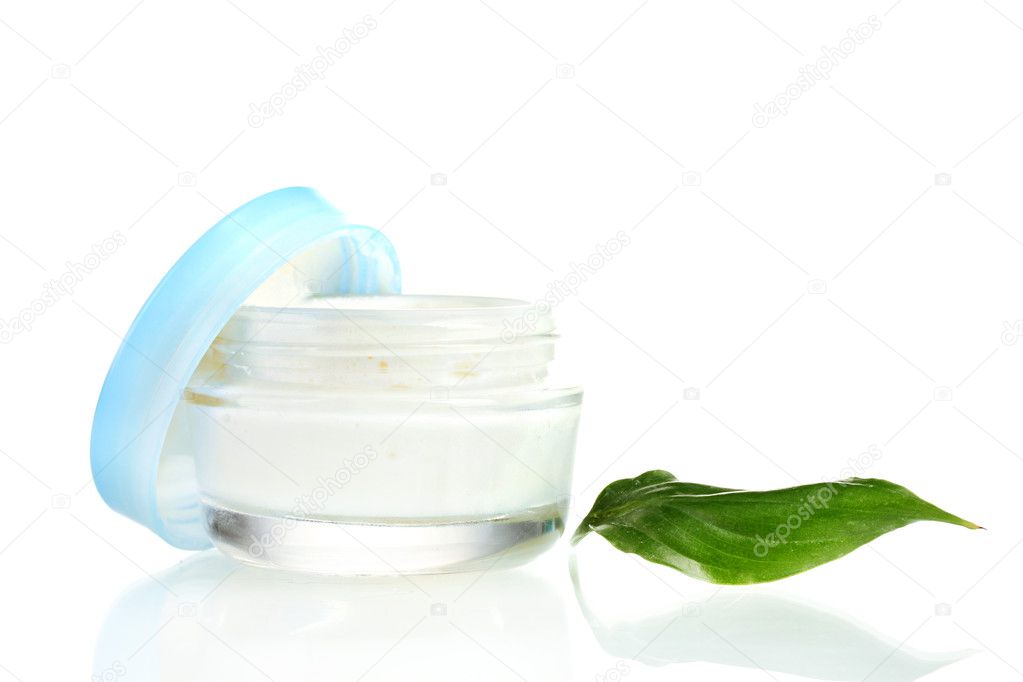 Opened glass jar of cream with fresh green leaf isolated on white