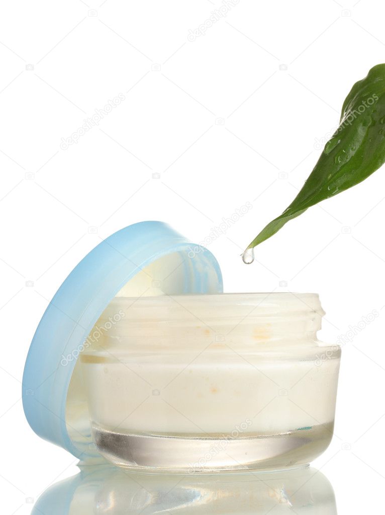 Opened glass jar of cream with fresh green leaf in water droplets isolated
