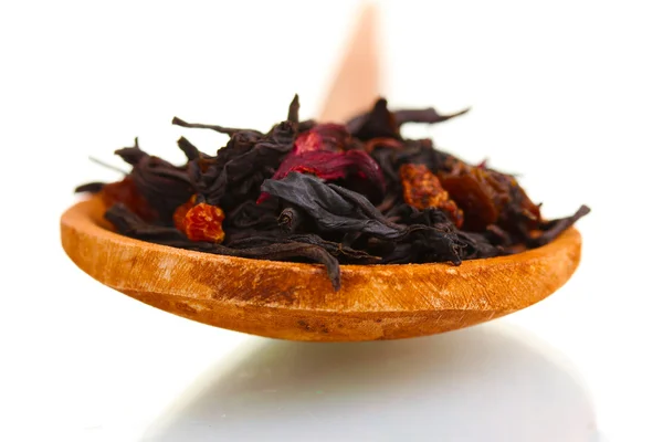Schwarze Früchte trockene Teeblätter in Holzlöffel isoliert auf weiß — Stockfoto