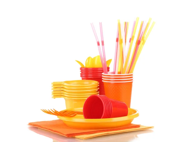Bright plastic tableware and napkins isolated on white — Stock Photo, Image