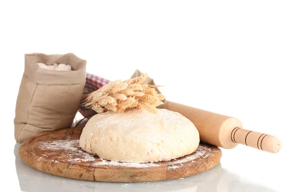 Dough and bags with flour on wooden board isolated on white — Stock Photo, Image