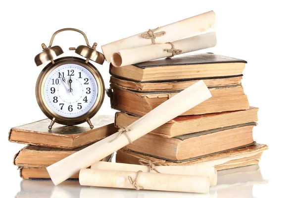 Pile of old books with clock and scroll isolated on white — Stock Photo, Image