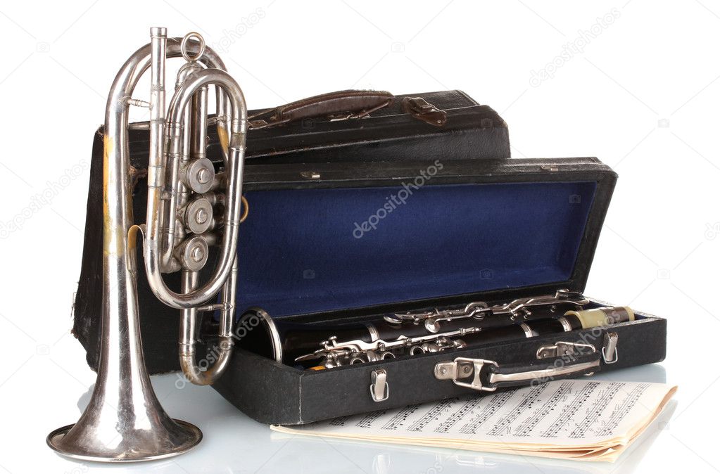 Antique trumpet and clarinet in case isolated on white