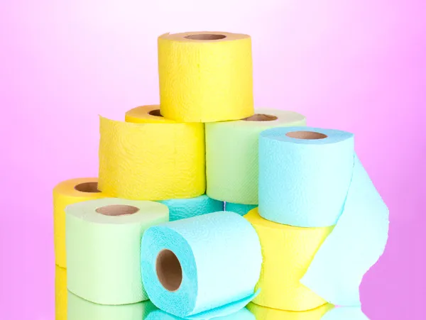 Bright rolls of toilet paper on pink background — Stock Photo, Image