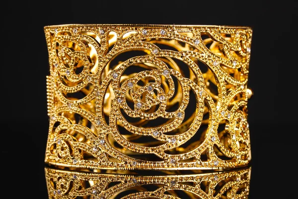 Beautiful golden bracelet on black background — Stock Photo, Image