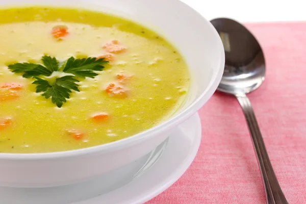 stock image Tasty soup on pink tablecloth isolated on white