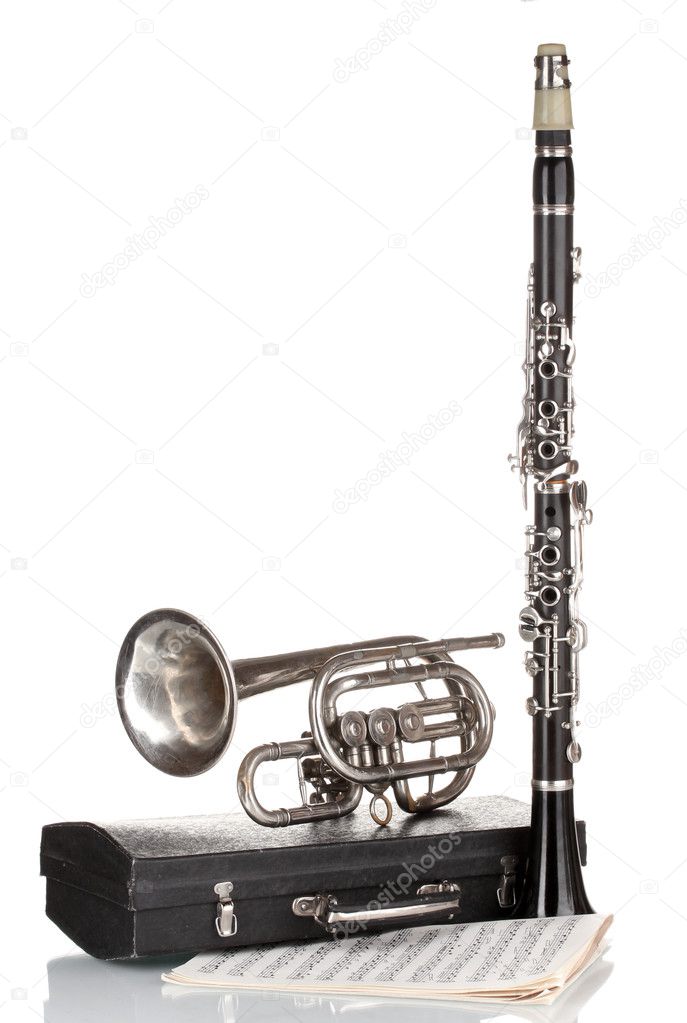 Antique trumpet, clarinet and case isolated on white