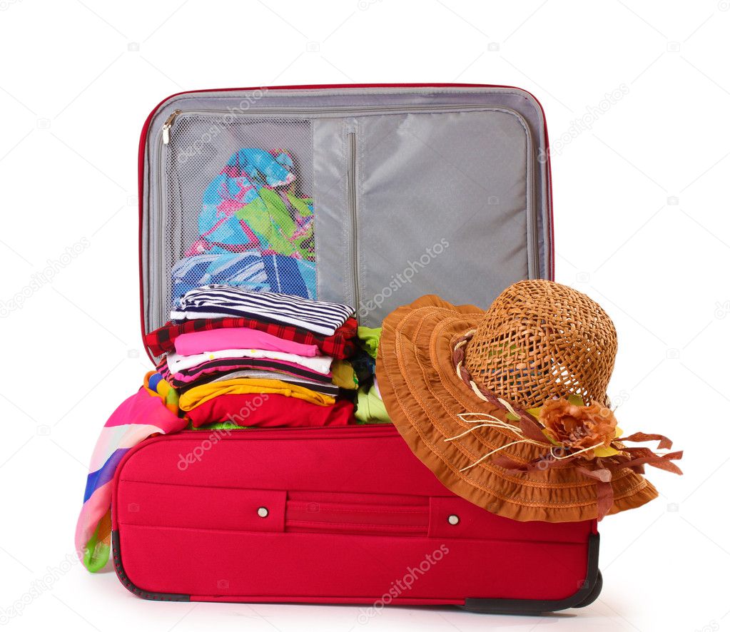 Open red suitcase with clothing isolated on a white