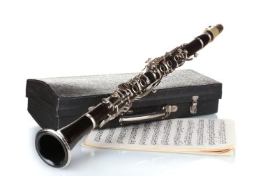 Antique clarinet, case and notebook with notes isolated on white clipart