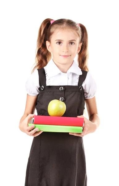 Hermosa niña en uniforme escolar, libros y manzana aislada en blanco — Foto de Stock