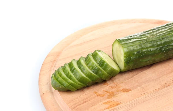 Long cucumber on wooden cutting board isolated on white — Stock Photo, Image