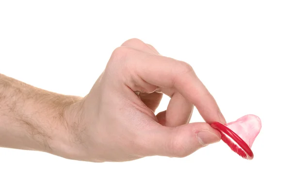 Рука держит презерватив изолированный на белом — стоковое фото