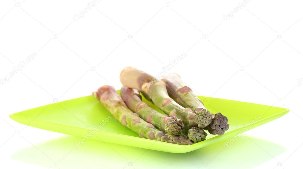 Delicious fresh asparagus on a plate isolated on white