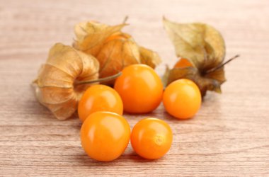 Physalis heap on wooden background clipart