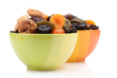 Dried fruits in bright bowls isolated on white