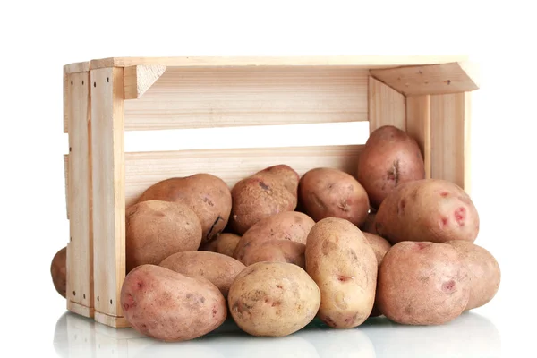 stock image Raw potatoes in a wooden box isolated on white