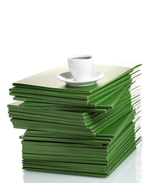 Viele grüne Ordner mit Tasse Kaffee isoliert auf weiß — Stockfoto