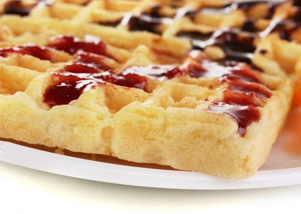 Sweet waffles with jam and chocolate on plate close-up isolated on white — Stock Photo, Image