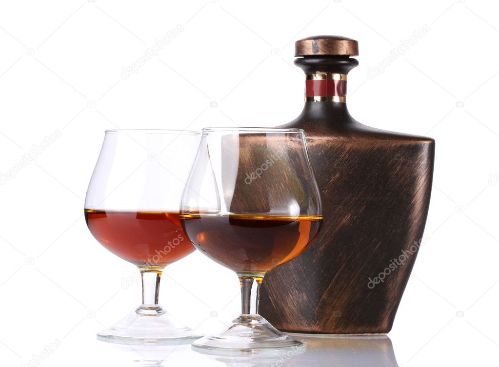 Glasses of brandy and bottle isolated on white