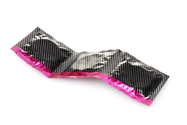 Beyaz izole paketinde üç prezervatif — Stok fotoğraf