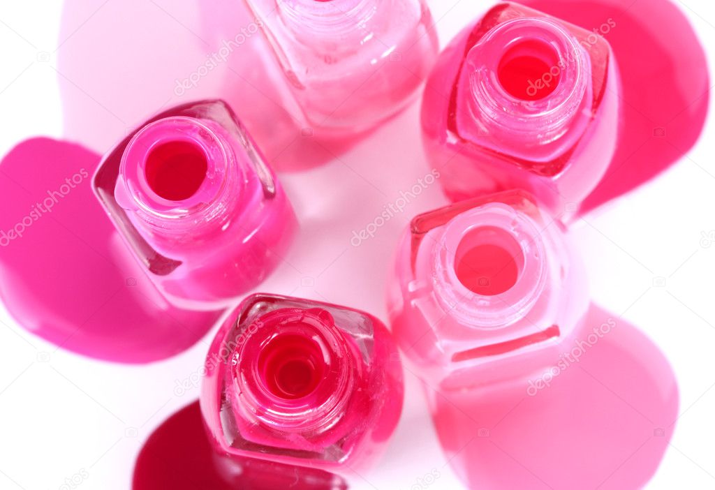 Open bottles with bright nail polish isolated on white