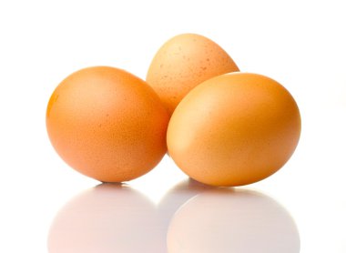 Three brown eggs isolated on white clipart