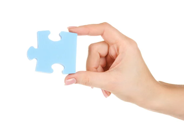 Blauwe puzzel met een hand geïsoleerd op wit — Stockfoto