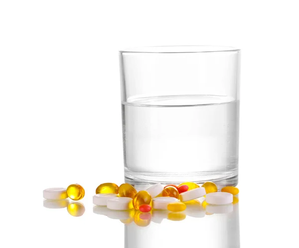 Glass of water and pills isolated on white — Stock Photo, Image