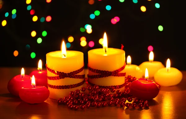 Hermosas velas y decoración en mesa de madera sobre fondo brillante —  Fotos de Stock