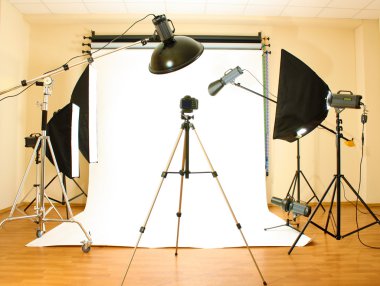 Empty photo studio with lighting equipment clipart