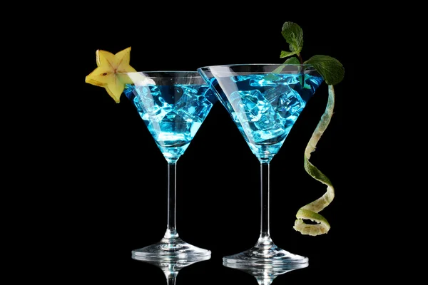 Blue cocktail in martini glasses on black background — Stock Photo, Image