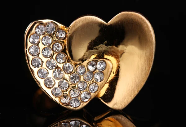 Hermoso anillo de oro con piedras preciosas sobre fondo negro — Foto de Stock