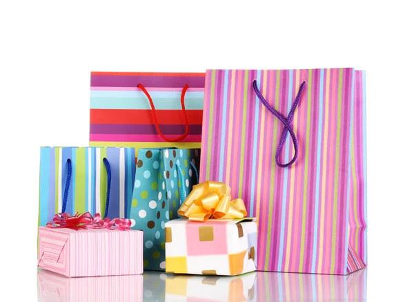Colorful gift bags with gifts isolated on white — Stock Photo, Image